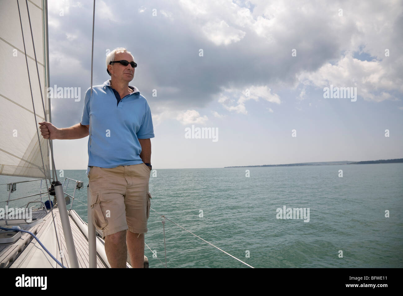 Mature man standing on a yacht Stock Photo - Alamy