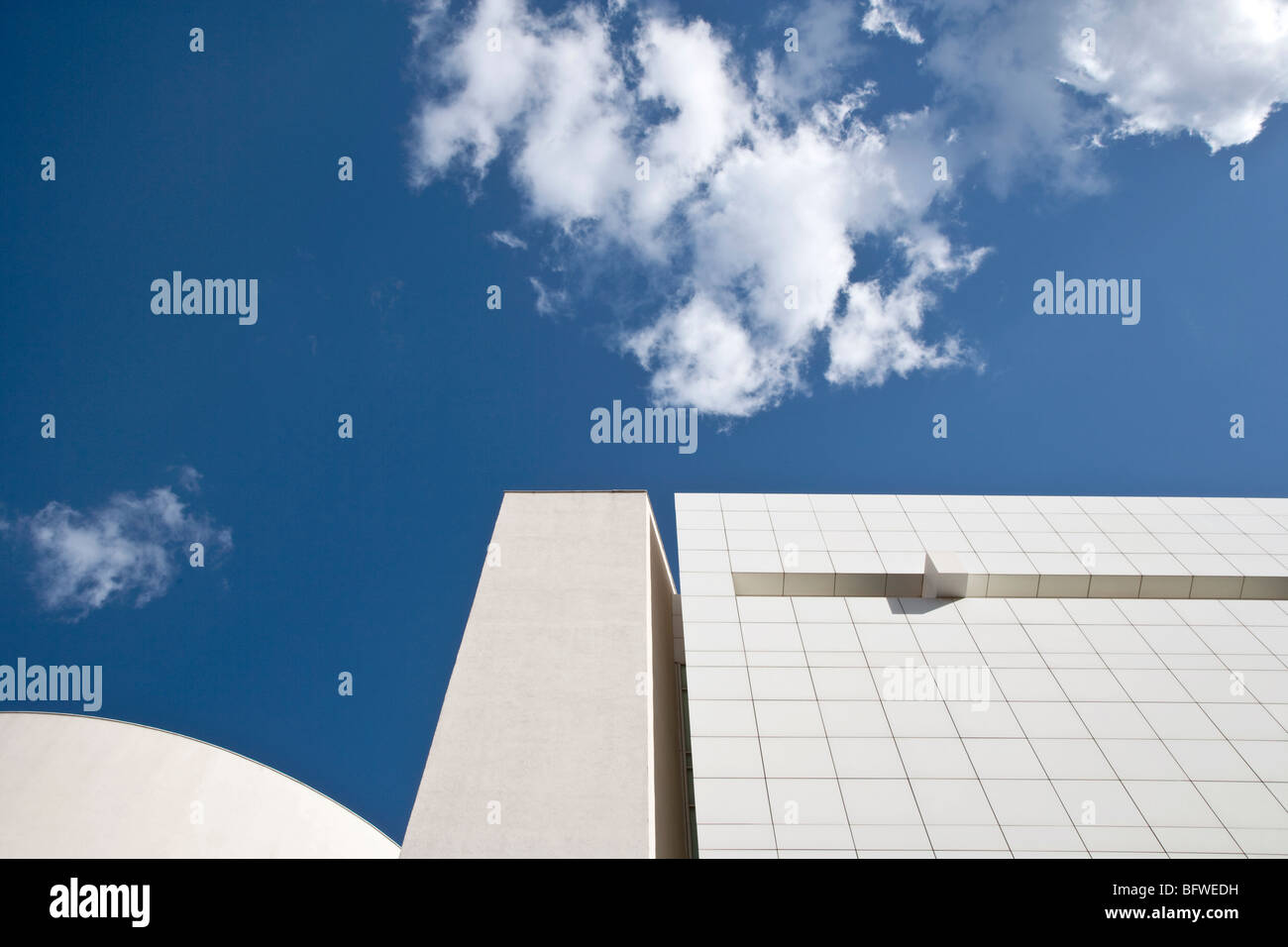 part of a white modern building against a blue sky Stock Photo - Alamy