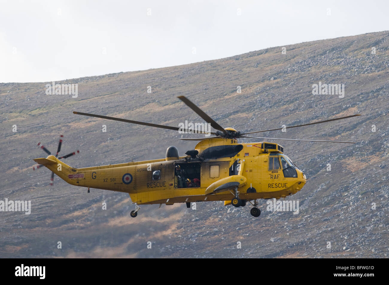 An RAF Sea King helicopter in the mountains of Cairngorms National Park, Scotland. Stock Photo