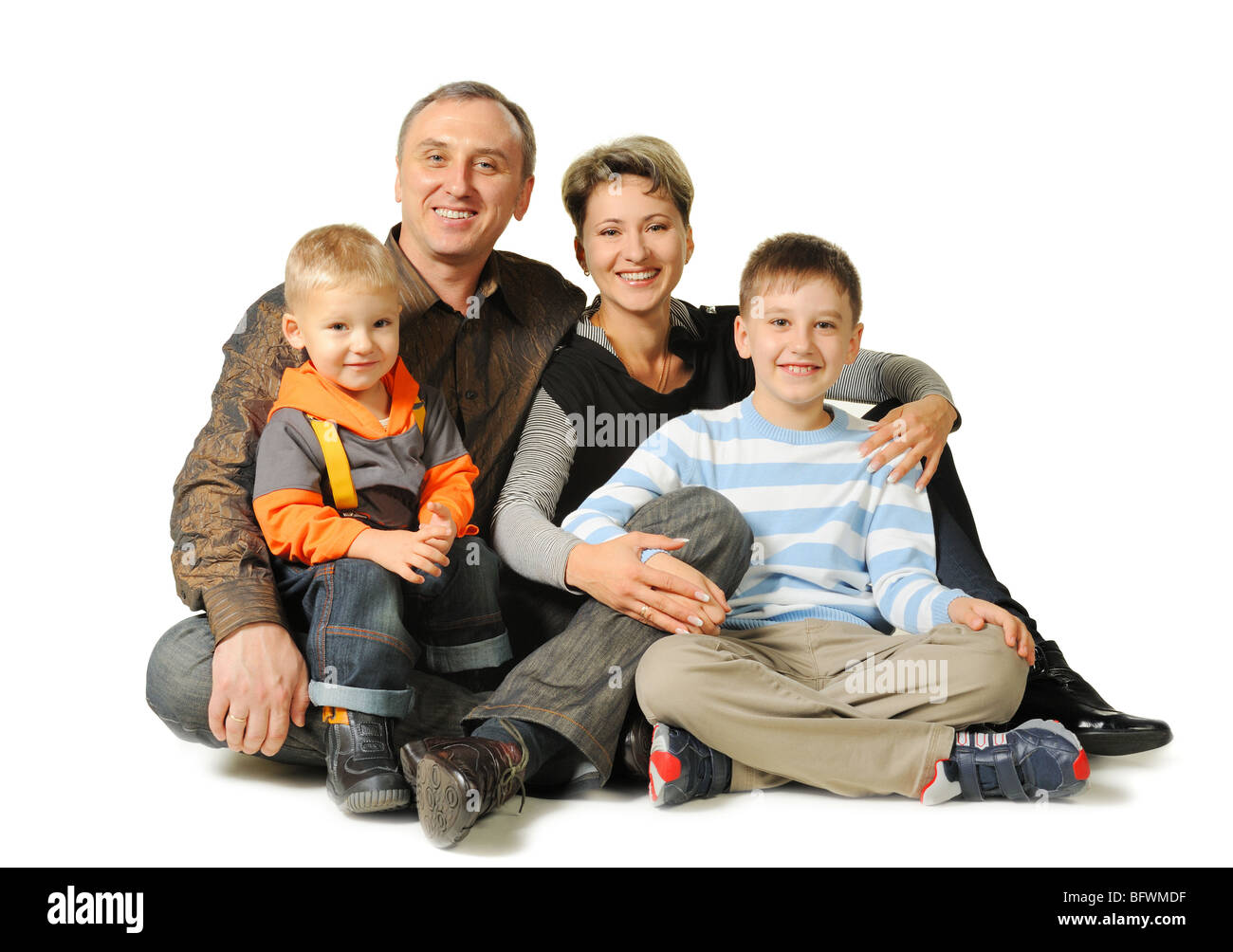 Happy family. The daddy, mum, two sons. It is isolated on a white ...