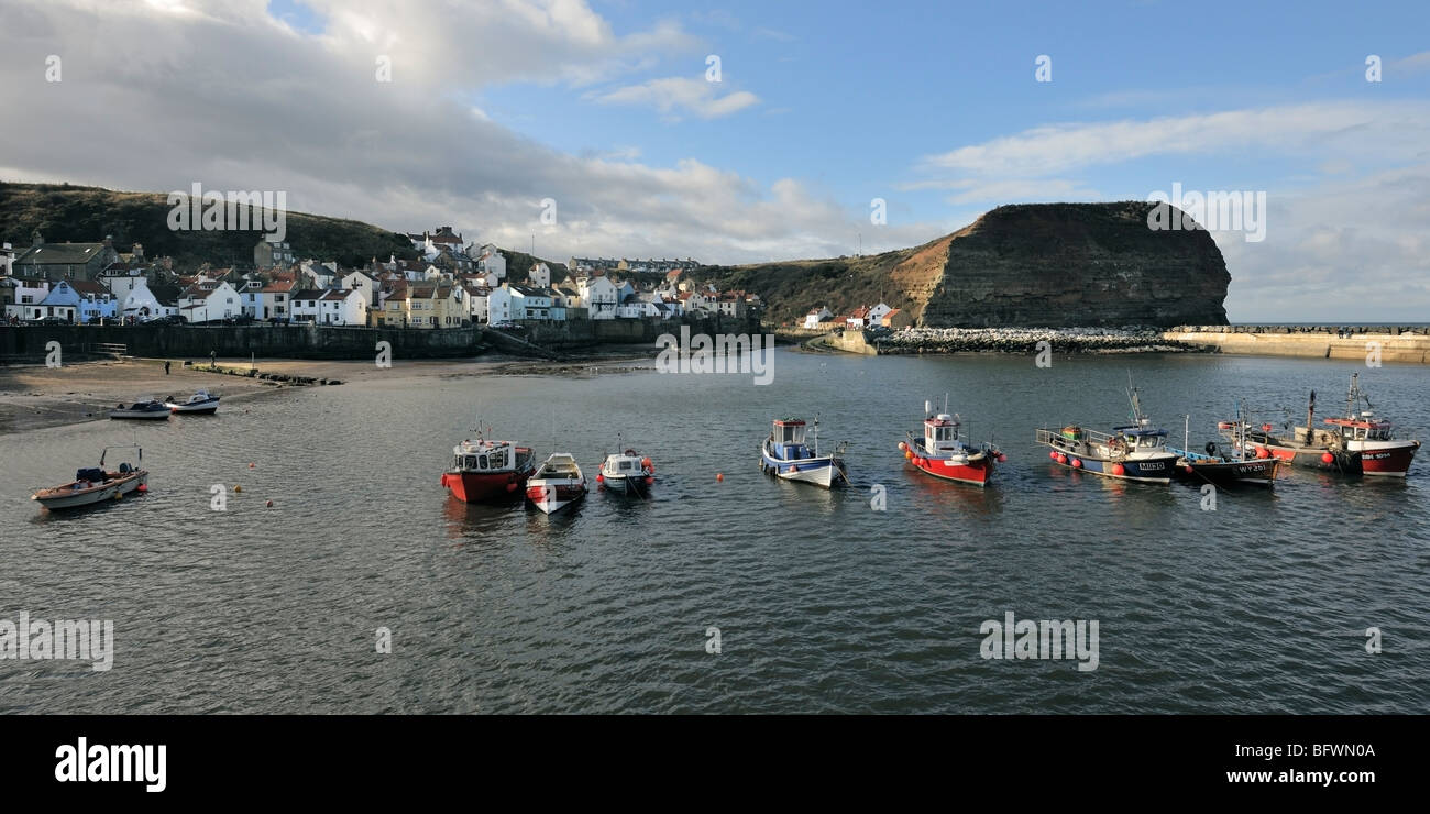 Fishing boats at anchor in the harbour at Staithes, Yorkshire Heritage Coast, England Stock Photo