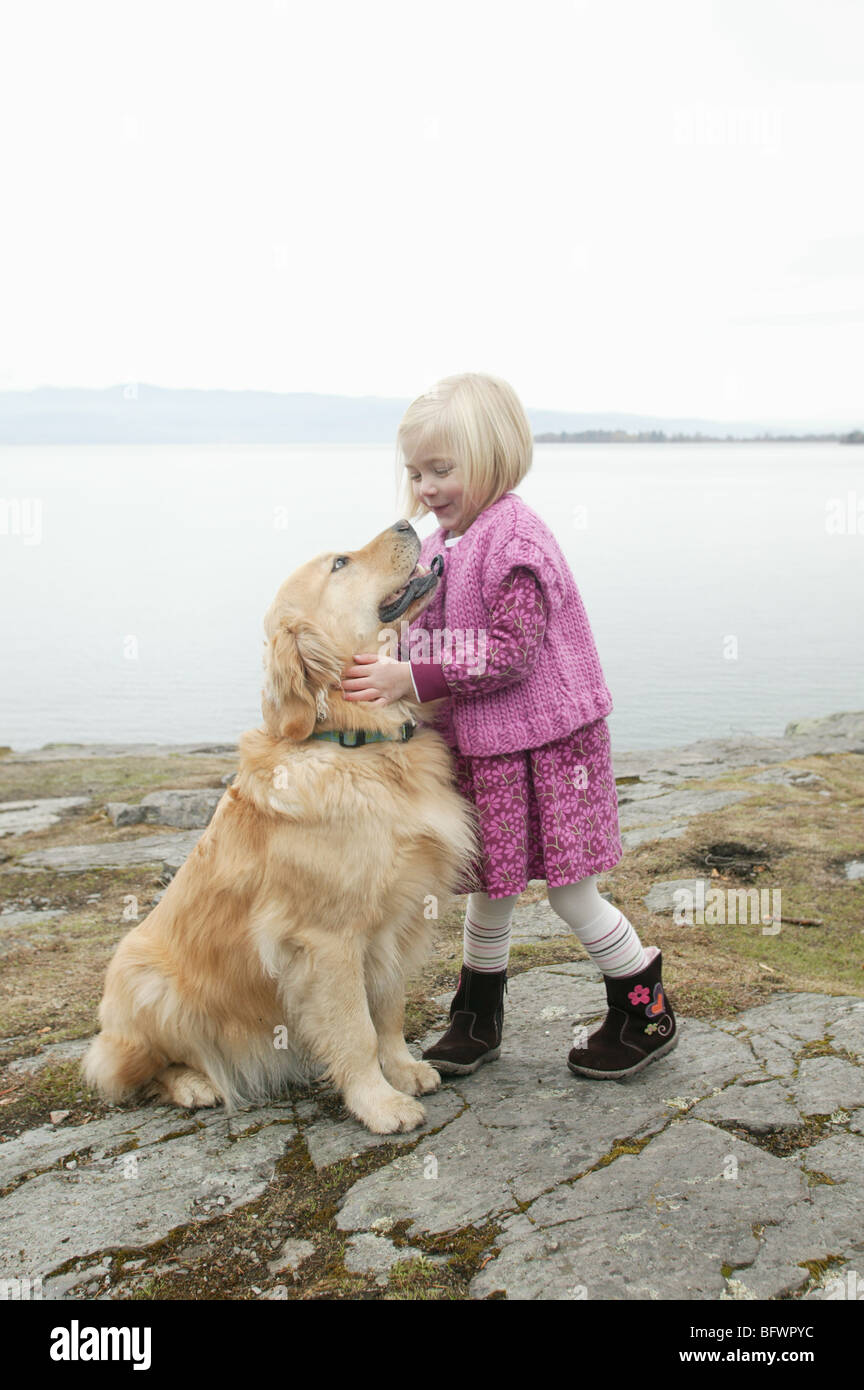 young girl with her golden retriever outdoors near lake Stock Photo - Alamy
