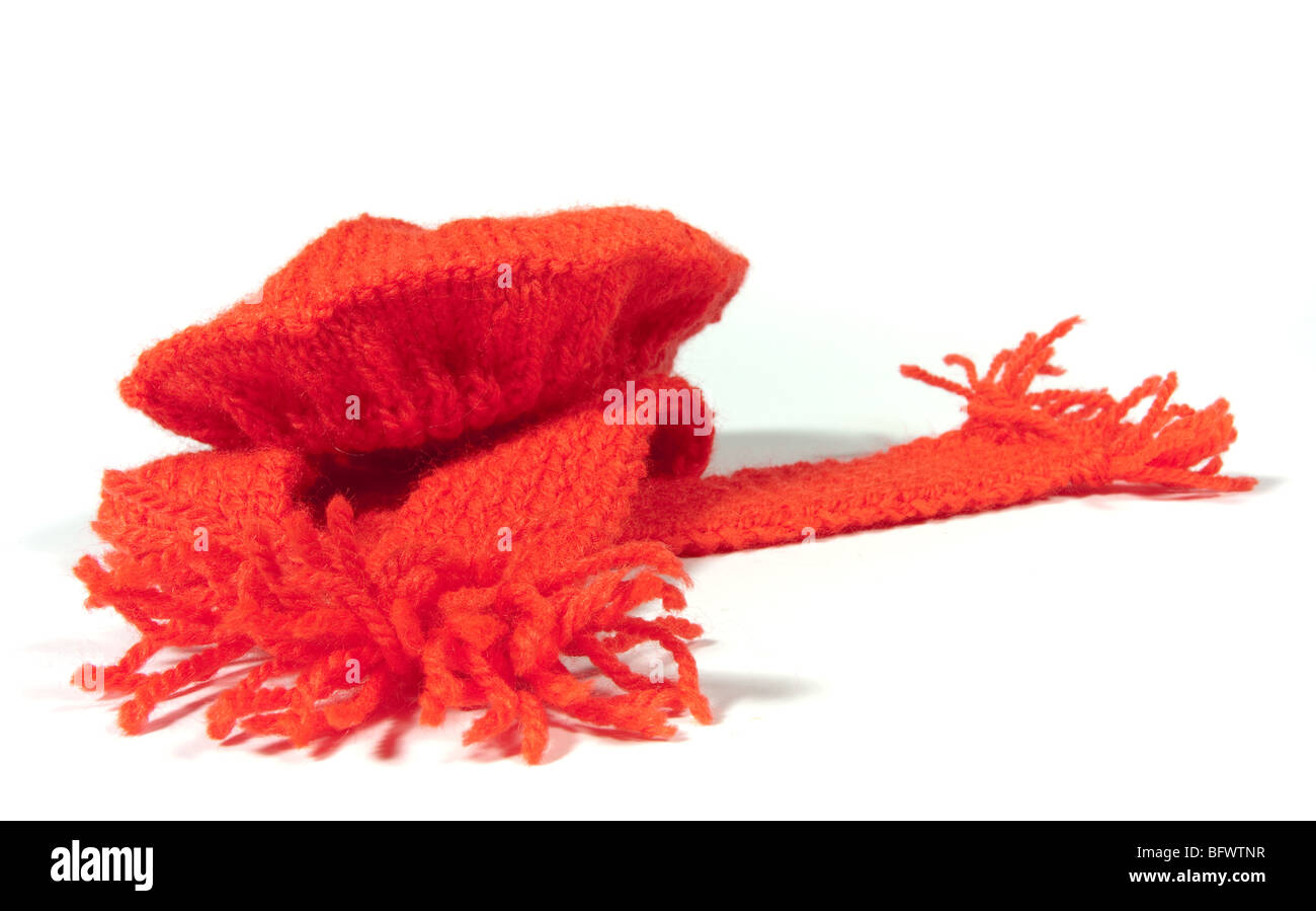 bright red knitted woolen scarf and beret isolated against white background. Stock Photo