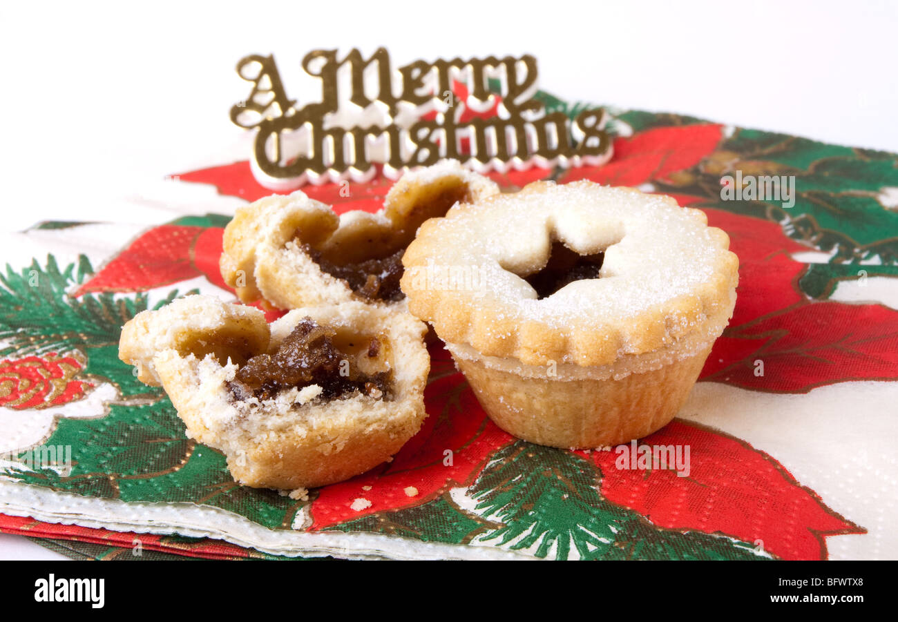 Sweet Mince Pies resting on christmas themed napkins Stock Photo