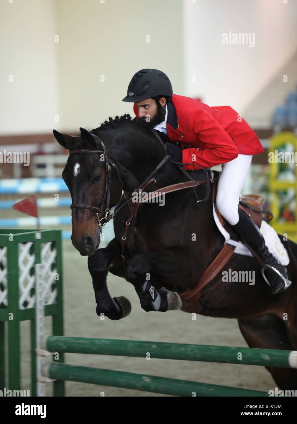 A regional showjumping competition at the Qatar Equestrian Federation's indoor arena in Doha Stock Photo