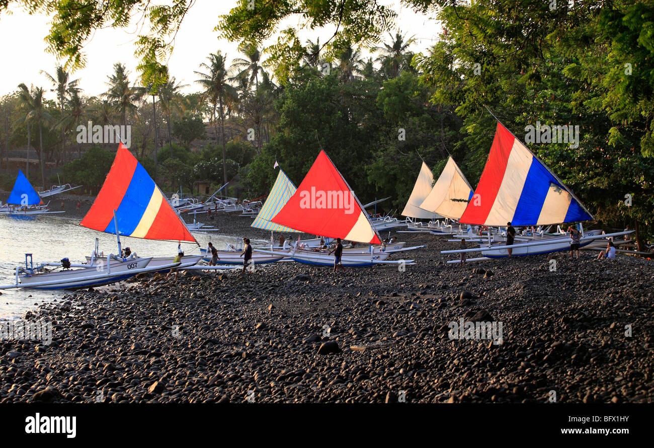 Jukungs, or Balinese fishing boats, pulled up on the beach, early morning. Tulamben, Bali, Indonesia Stock Photo