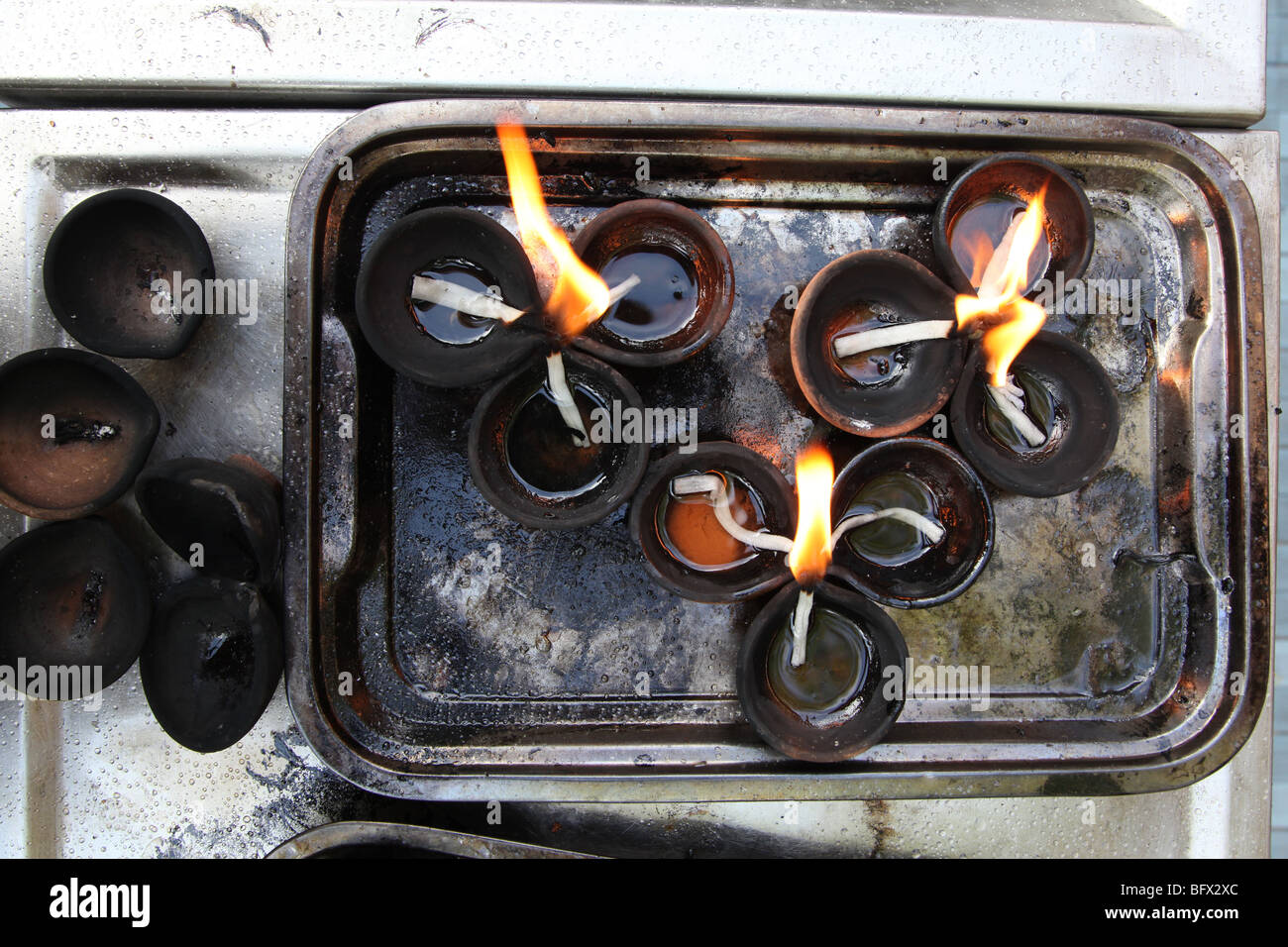 Candles burn in the Gangaramaya temple in Colombo, Sri Lanka. Stock Photo