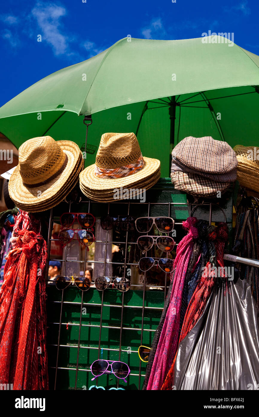 Stall selling hats, umbrellas, scarves and sunglasses in Canterbury, Kent Stock Photo