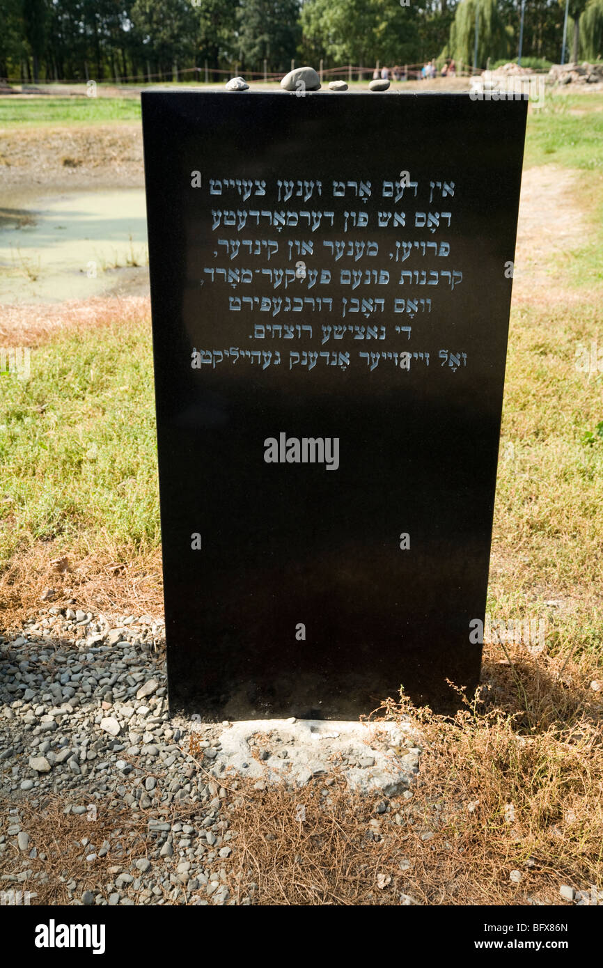 Memorial stone to the victims of the holocaust inside Birkenau (Auschwitz II - Birkenau) Nazi death camp in Oswiecim, Poland. Stock Photo