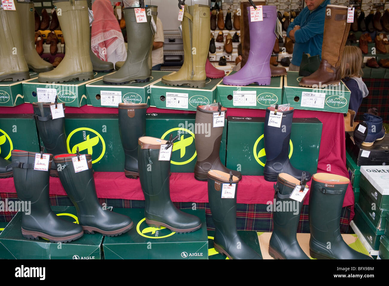 A stall selling green wellington boots at a festival in the English ...