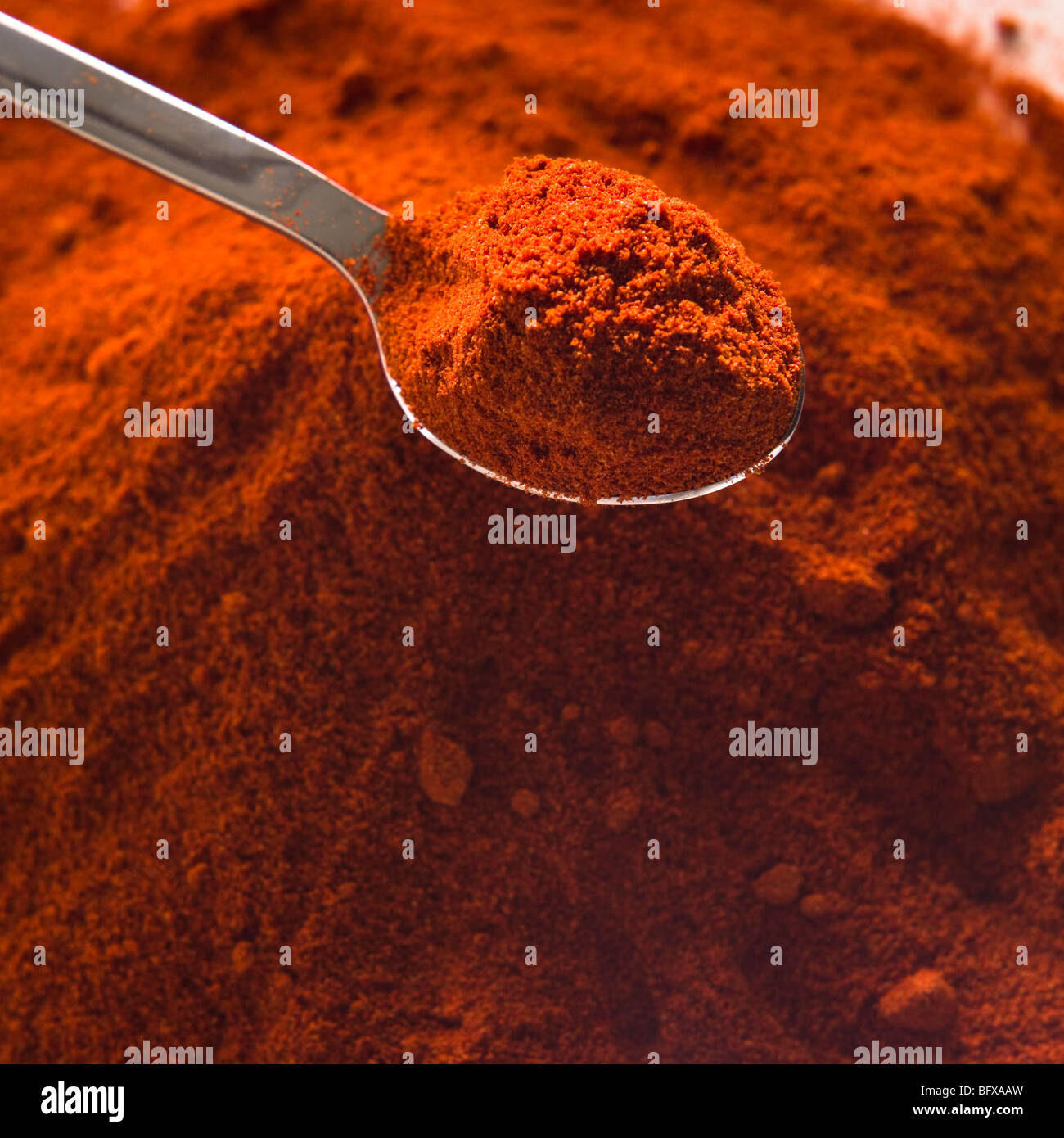 Pile of curry powder and spoon Stock Photo