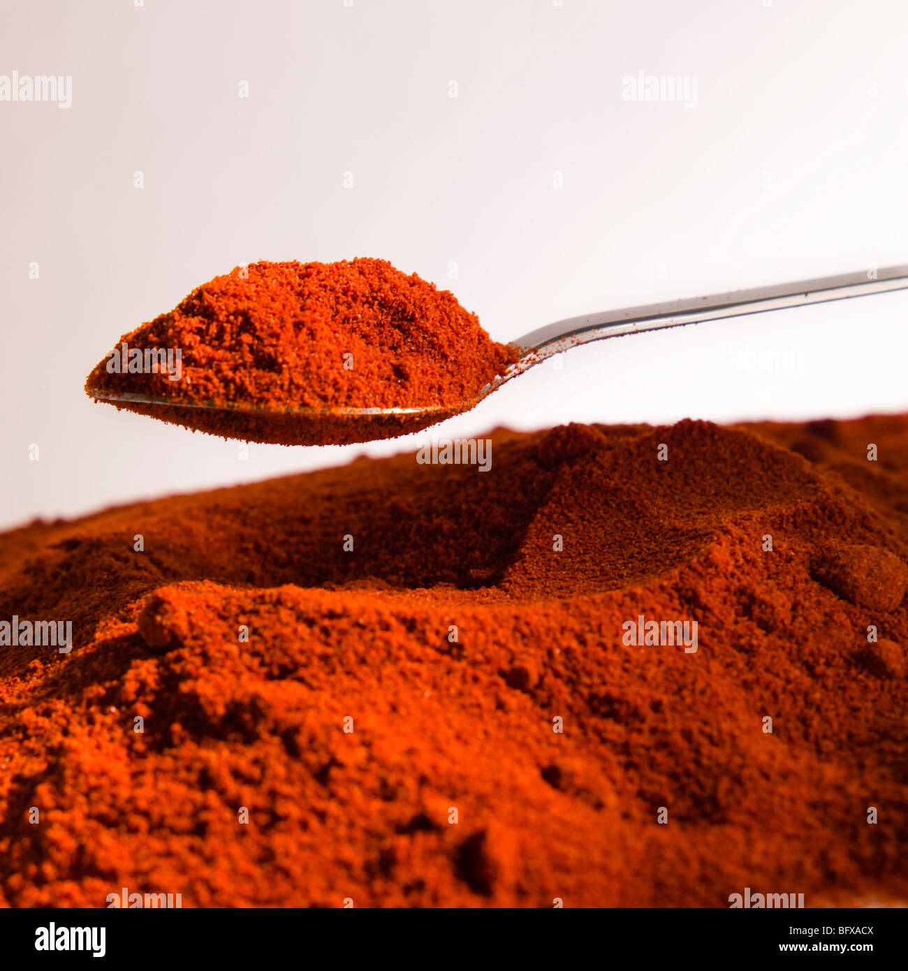 Pile of curry powder and spoon Stock Photo