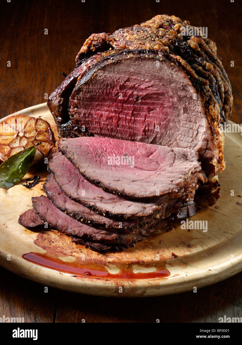 Irish roast beef joint with roasted garlic Stock Photo Alamy