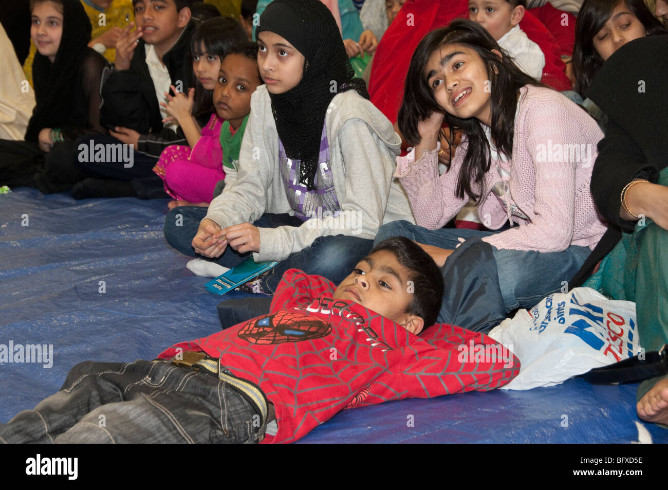 Children watch talent show at Eid Milad-Un-Nabi Celebrations at Sunni Muslim Association, Tooting, London. Stock Photo
