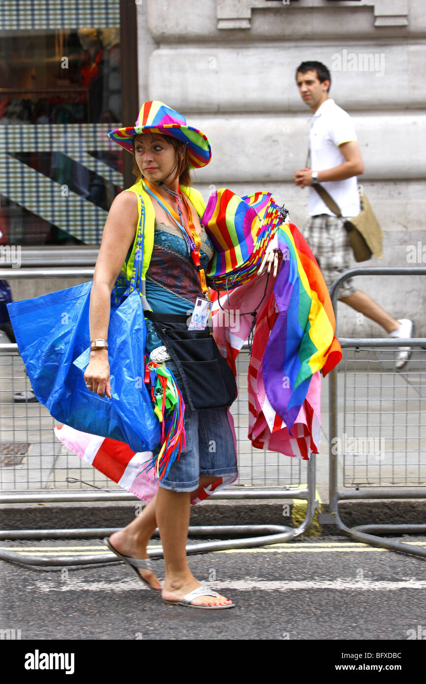 Woman selling Gay Pride flags hats and whistles at London's Gay