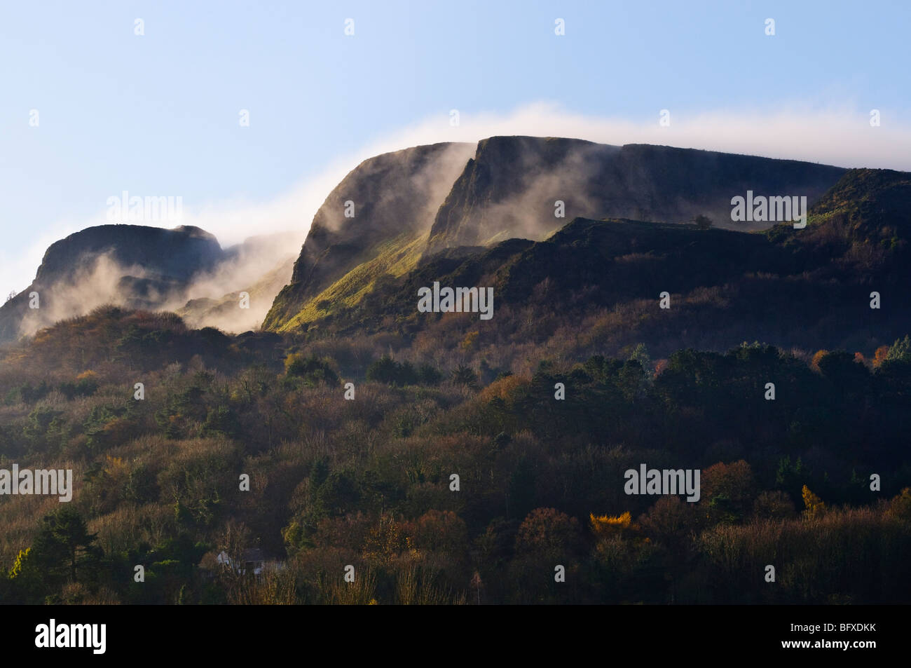 Mist/low clouds roll over 'Napoleon's Nose', Cave Hill, Belfast in late autumn sunshine Stock Photo