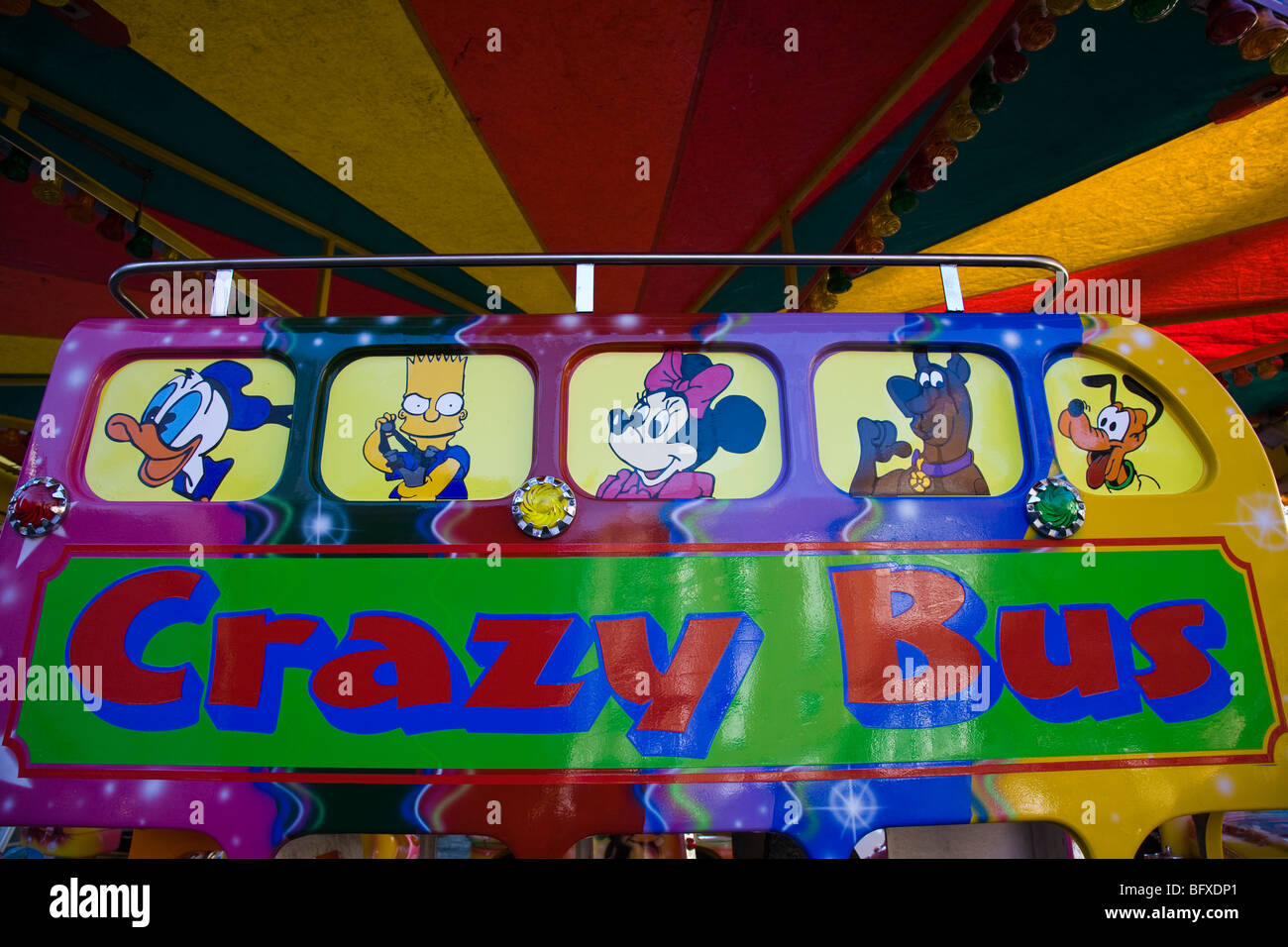 Part of a colourful toy bus ride on a town fairground. Stock Photo