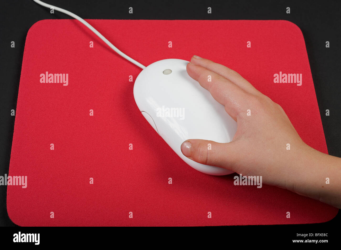 Child's hand controlling a computer's mouse Stock Photo