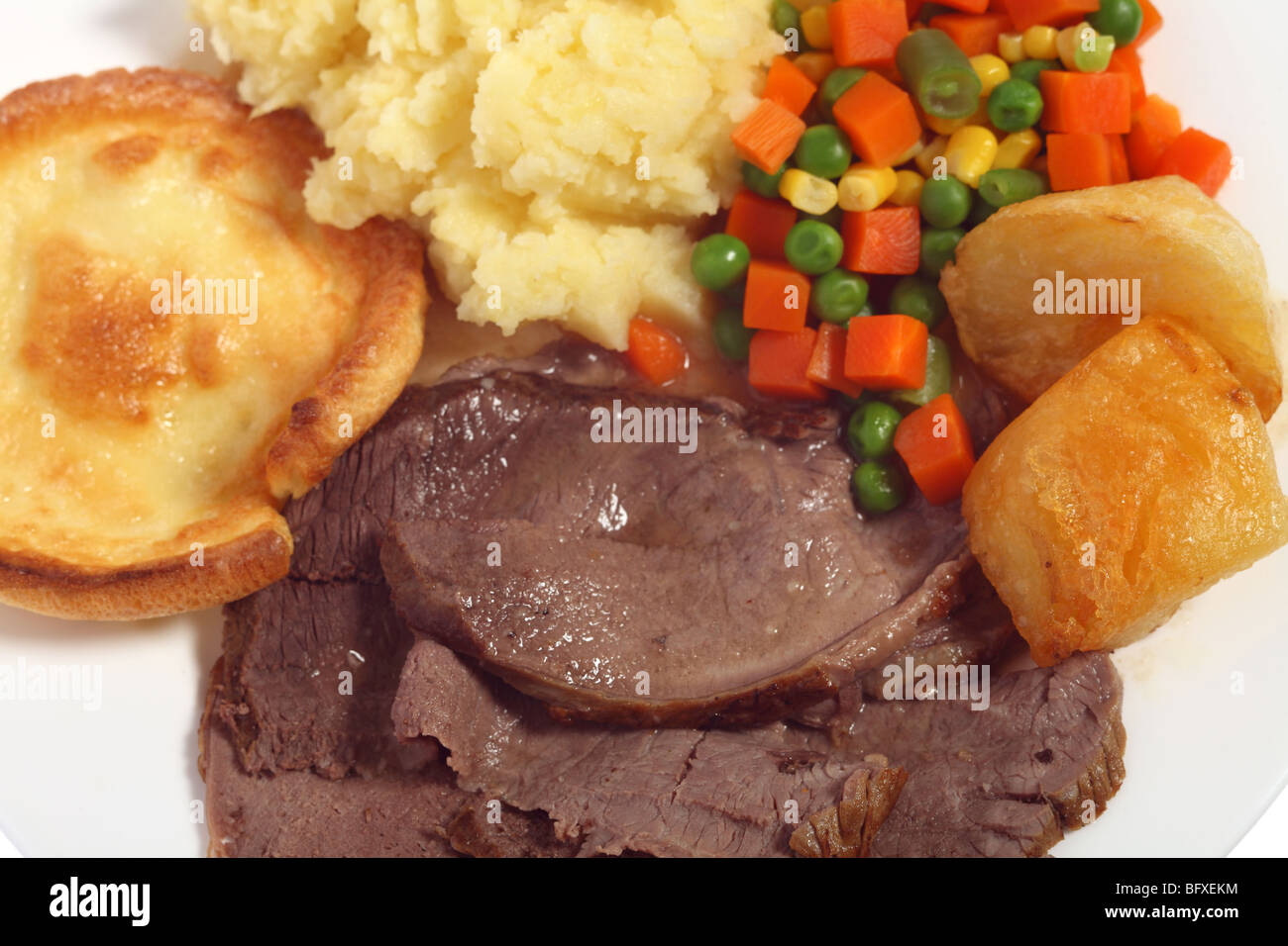A meal of roast beef yorkshire pudding and vegetables from above Stock