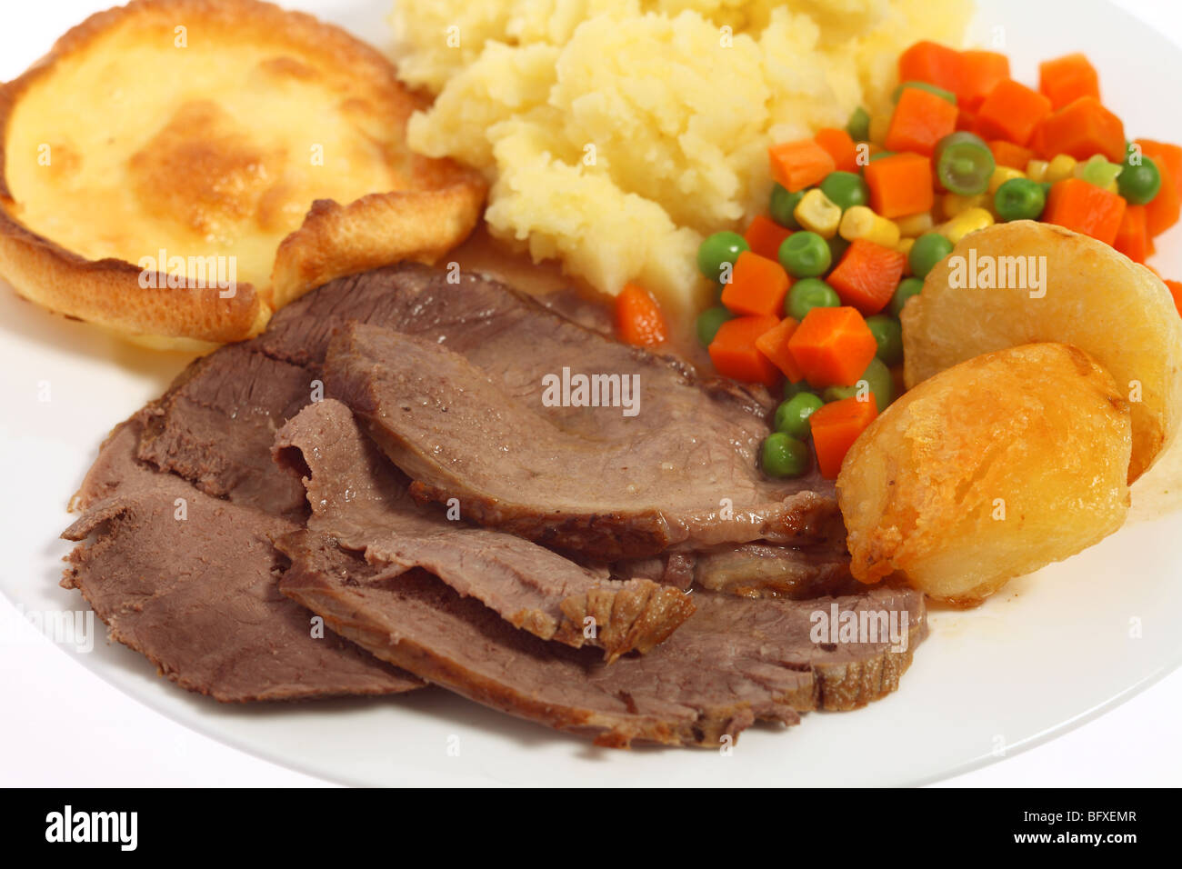 A meal of roast beef, yorkshire pudding,mixed veg and mashed and