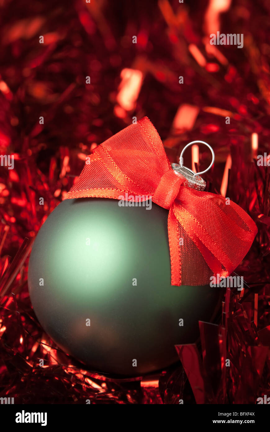 Green christmas ball on the red tinsel. aRGB Stock Photo - Alamy