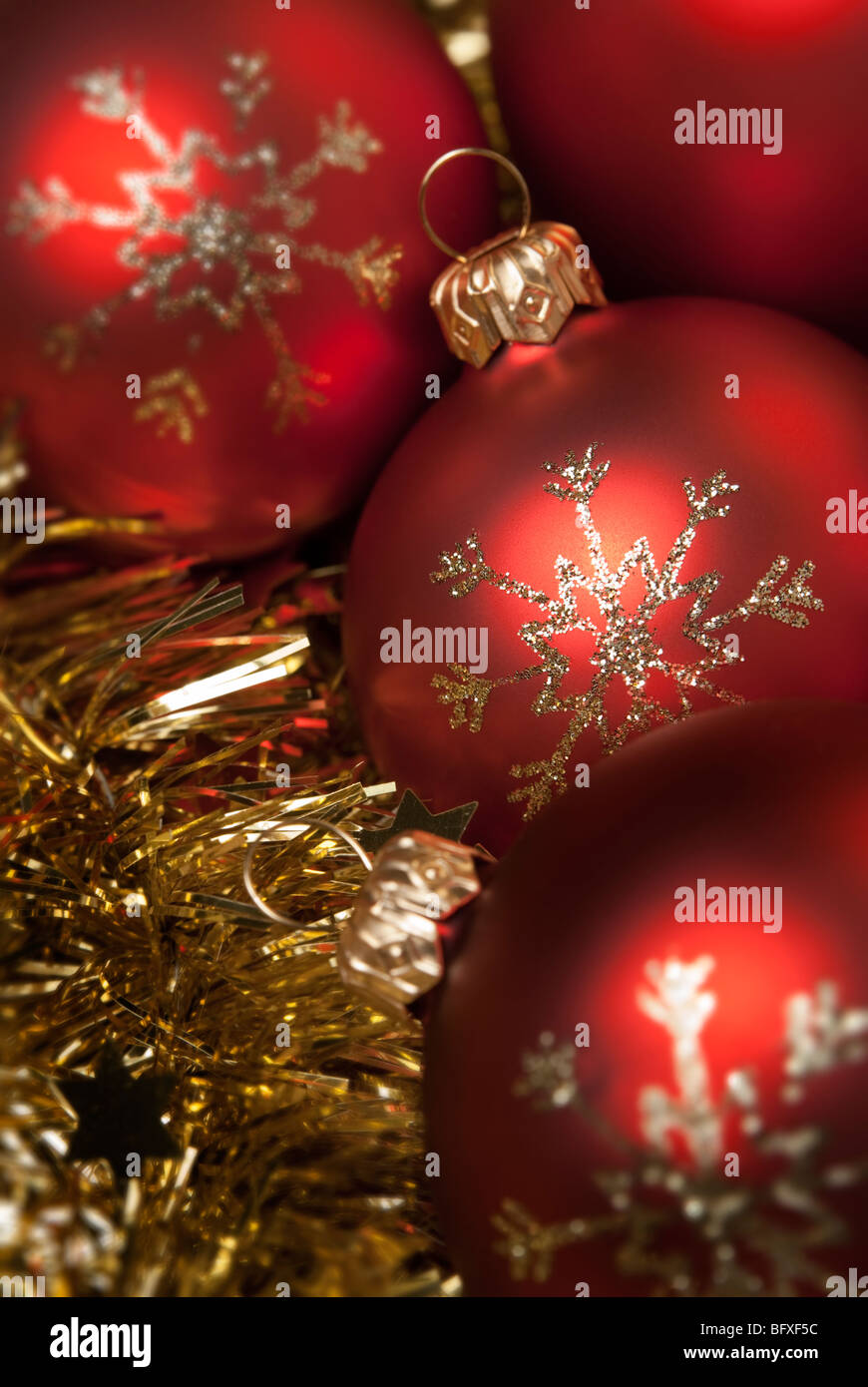 Red christmas ball on the gold tinsel. aRGB. Stock Photo