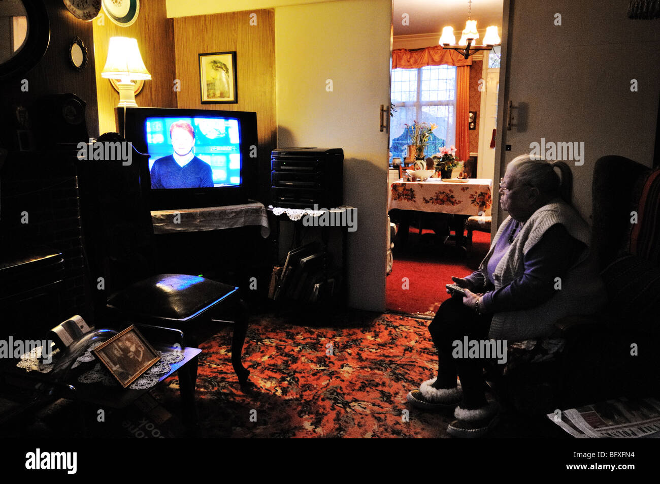 Old lady watching television Stock Photo