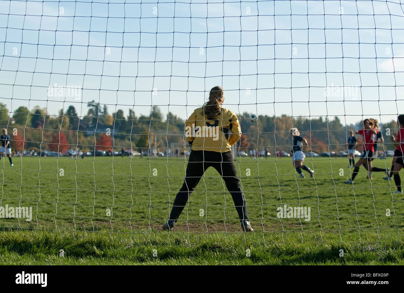 Female soccer goalkeeper guarding goal. Stock Photo