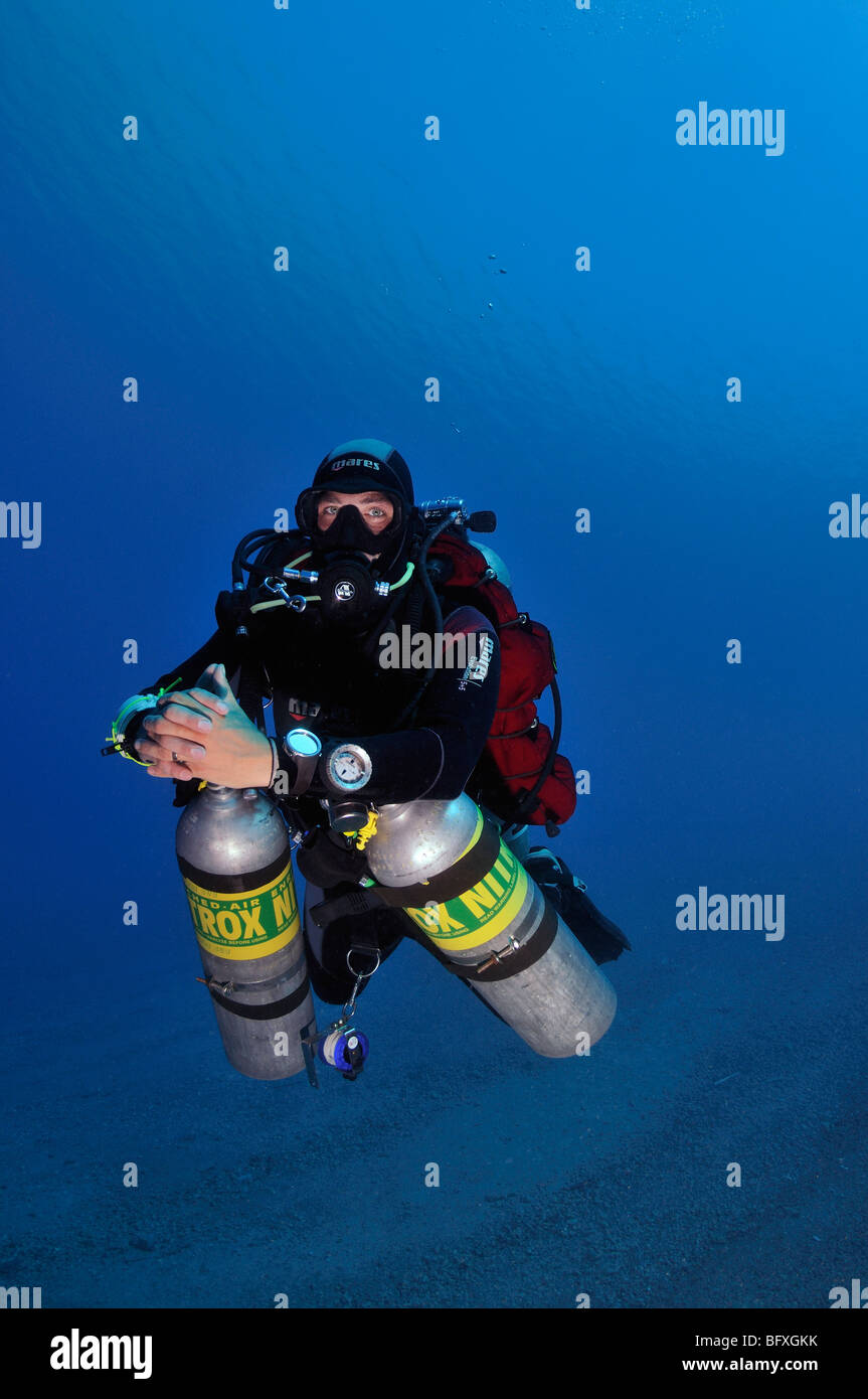Technical scuba diver diving underwater with multiple cylinders Ras Abu Gallum, "Red Sea" Stock Photo
