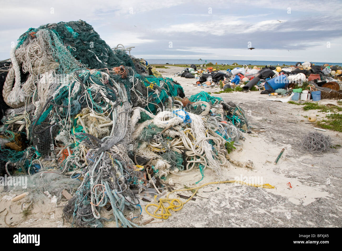 Abandoned fishing nets, ropes and other marine debris washed ashore by ocean currents, collected to be shipped off island for recycling or disposal Stock Photo