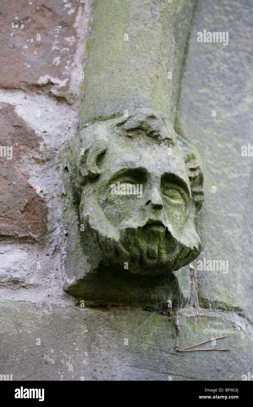 A stone head mould stop on gothic church window, St Gregory's Church, Offchurch, Warwickshire Stock Photo