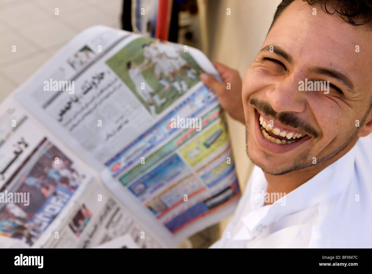 Egypt, Sharm el Sheik, boy reading newspaper Stock Photo