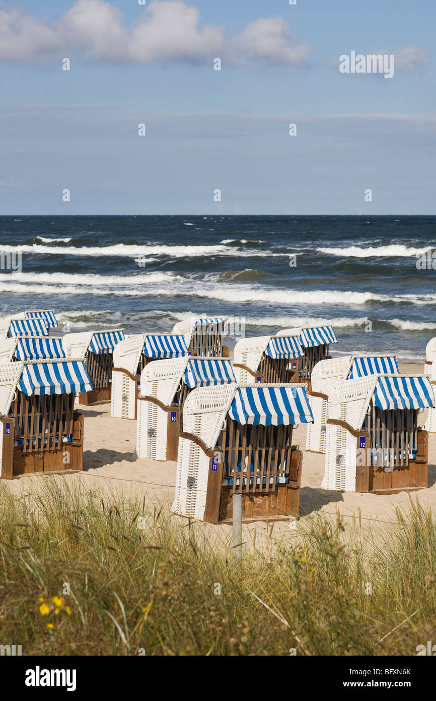 Empty roofed wicker beach chair at beach, Ruegen, Germany Stock Photo