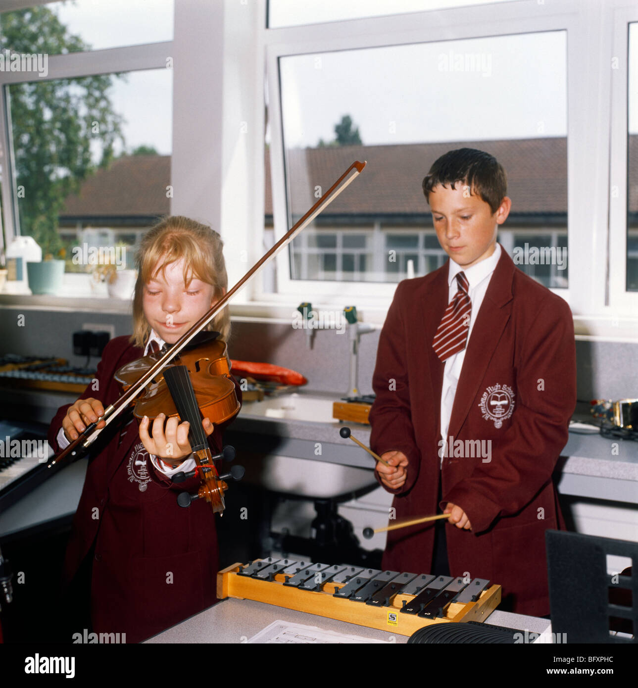 High School Music Class Students Playing Violin And Xylophone Stock Photo