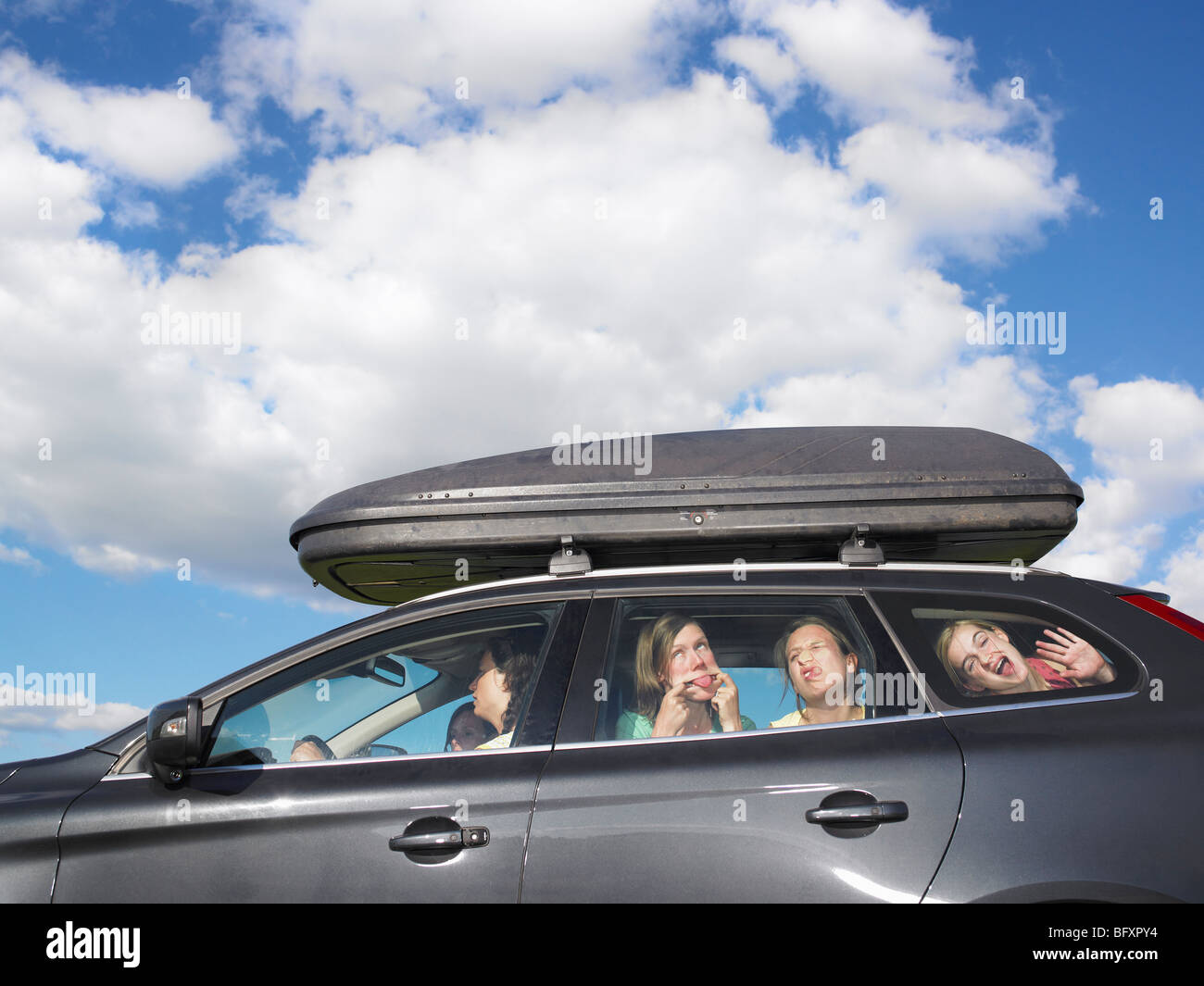 girls making faces in car Stock Photo Alamy