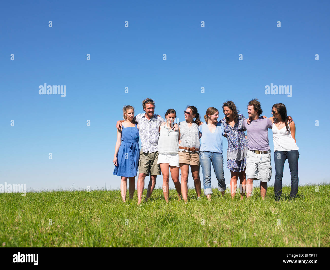 group of young people walking in field Stock Photo - Alamy