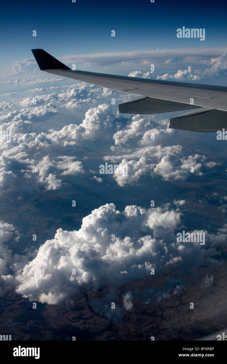 View from airplane window flying above the clouds between Perth and Sydney in Australia Stock Photo