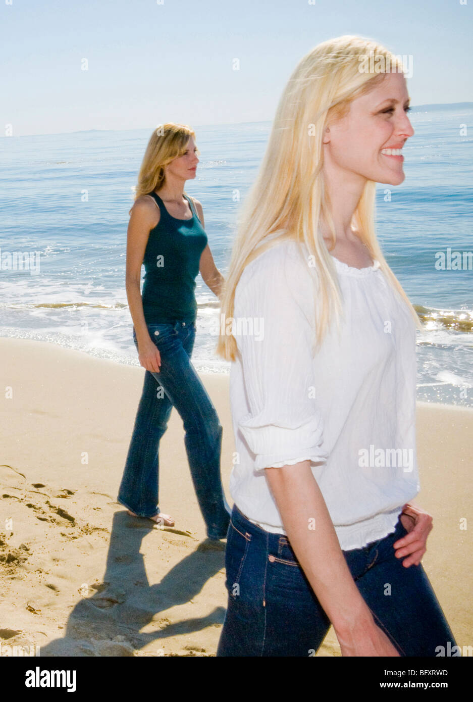 Women walking on beach Stock Photo - Alamy