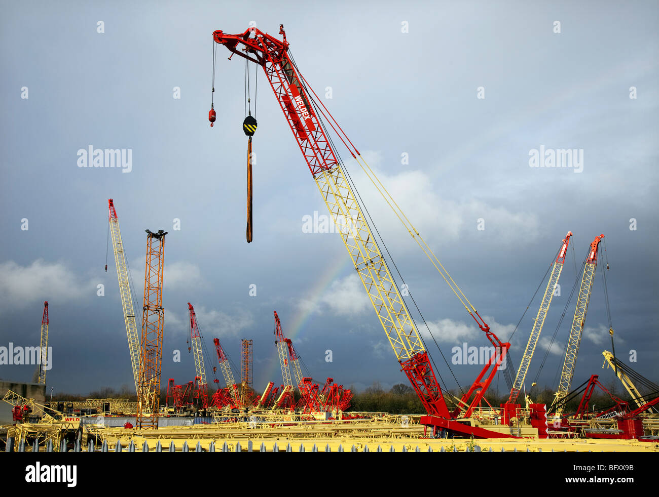 Construction equipment  & several Weldex Cranes in secure storage yard, Derbyshire, UK Stock Photo