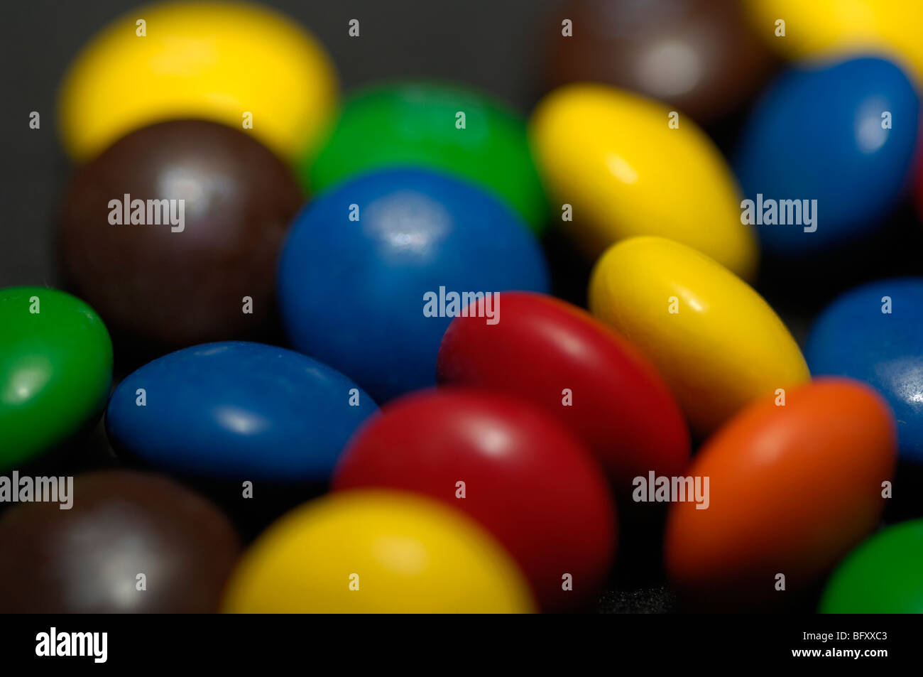 Multicoloured sugar coated chocolates Stock Photo Alamy