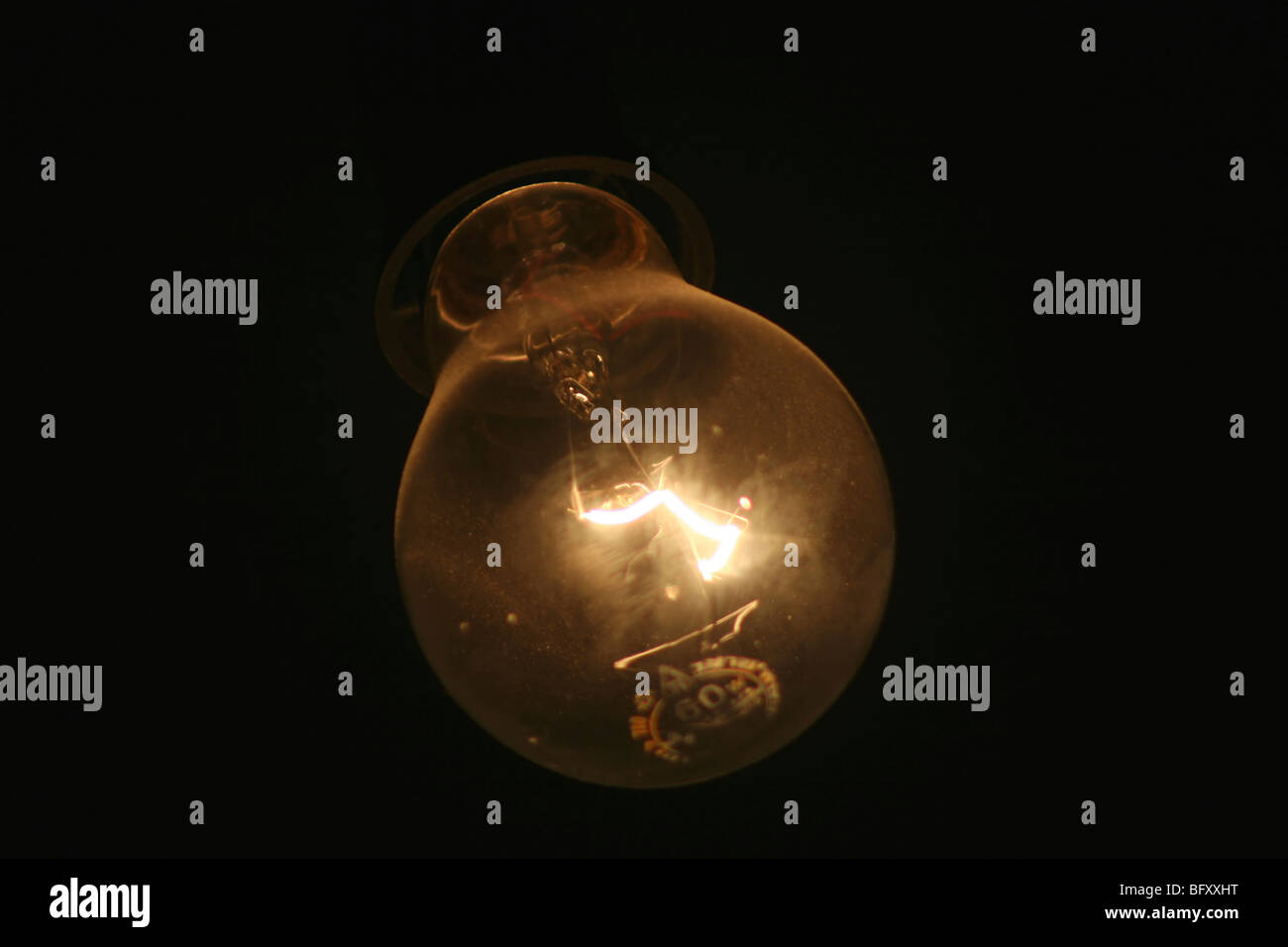 Burning incandescent lamp light bulb on black background Stock Photo