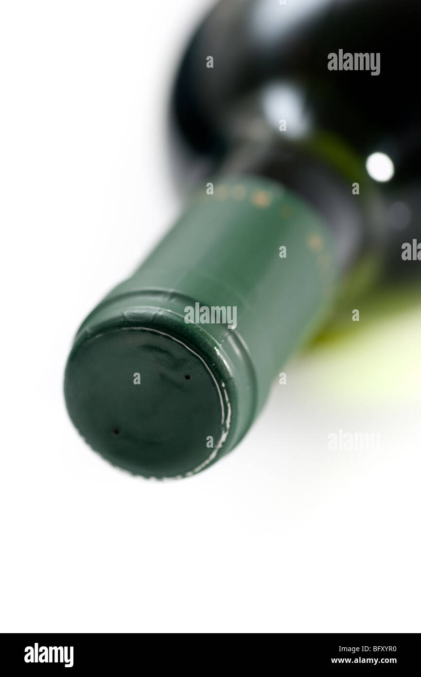 Closeup of the neck and spout of a wine bottle, lying on its side. Stock Photo