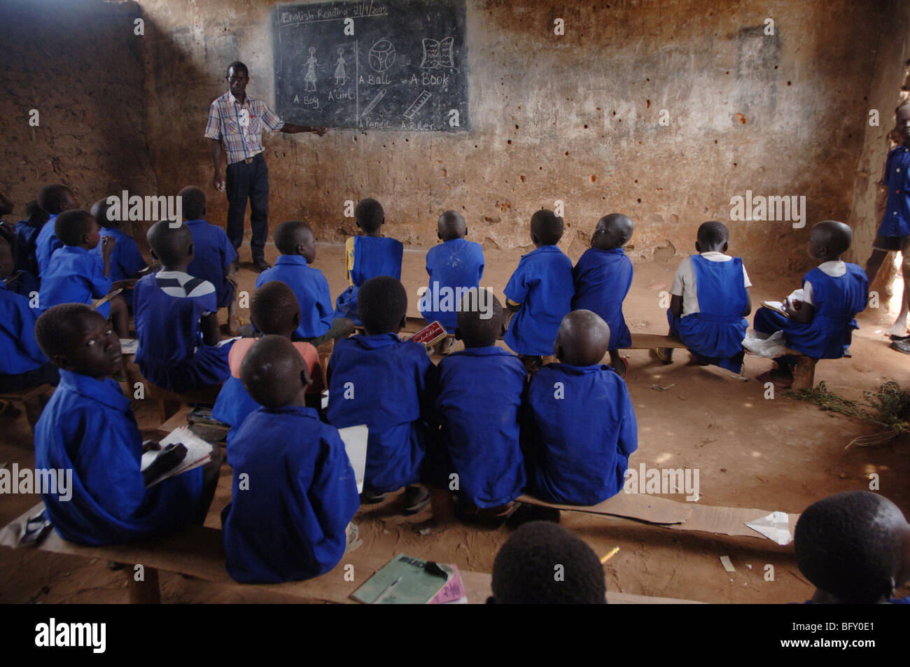 Pupils learning at a school classroom that has been scarred by thousands of bullets during the 34 year war in Yei, Sudan. Stock Photo