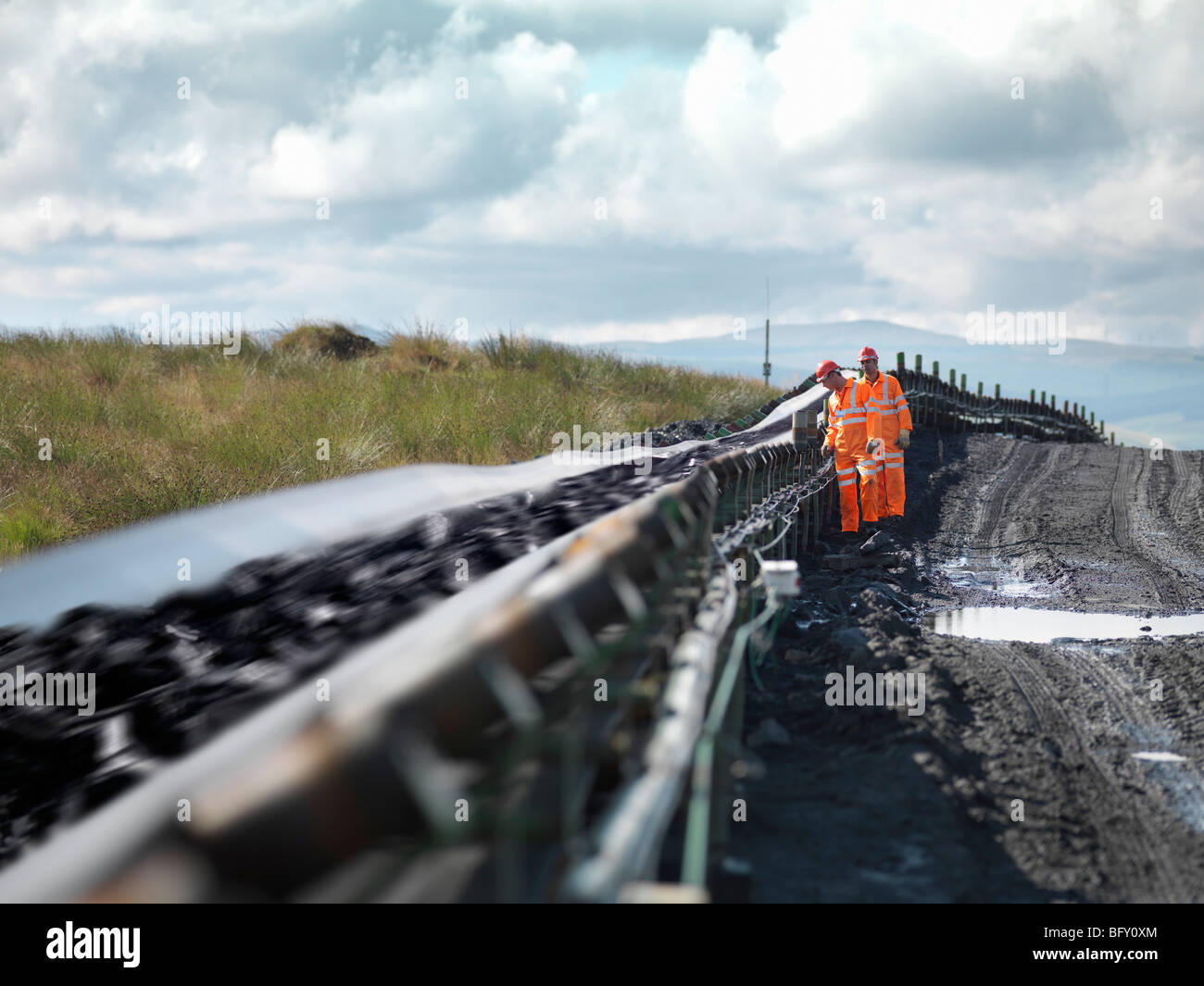 Coal Workers Inspecting Conveyor Belt Stock Photo