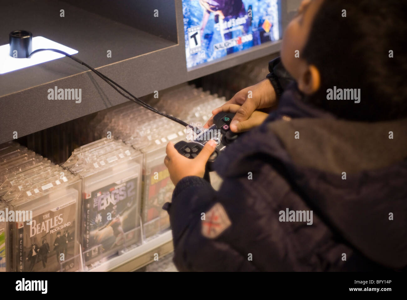 A child plays with a Sony Playstation in the Times Square Toys R Us store in New York Stock Photo