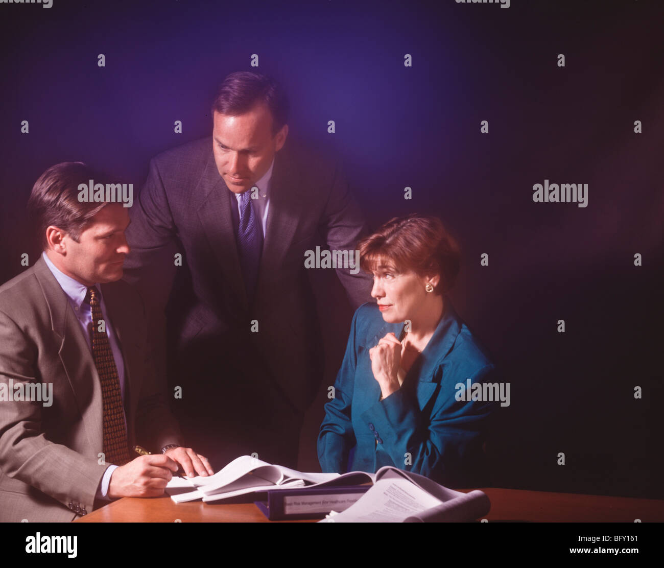 Group of office workers in conference meeting reacting while trying to reach agreement on corporate plans. Stock Photo