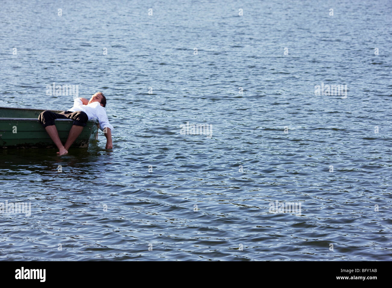 businessman relaxing in rowboat Stock Photo
