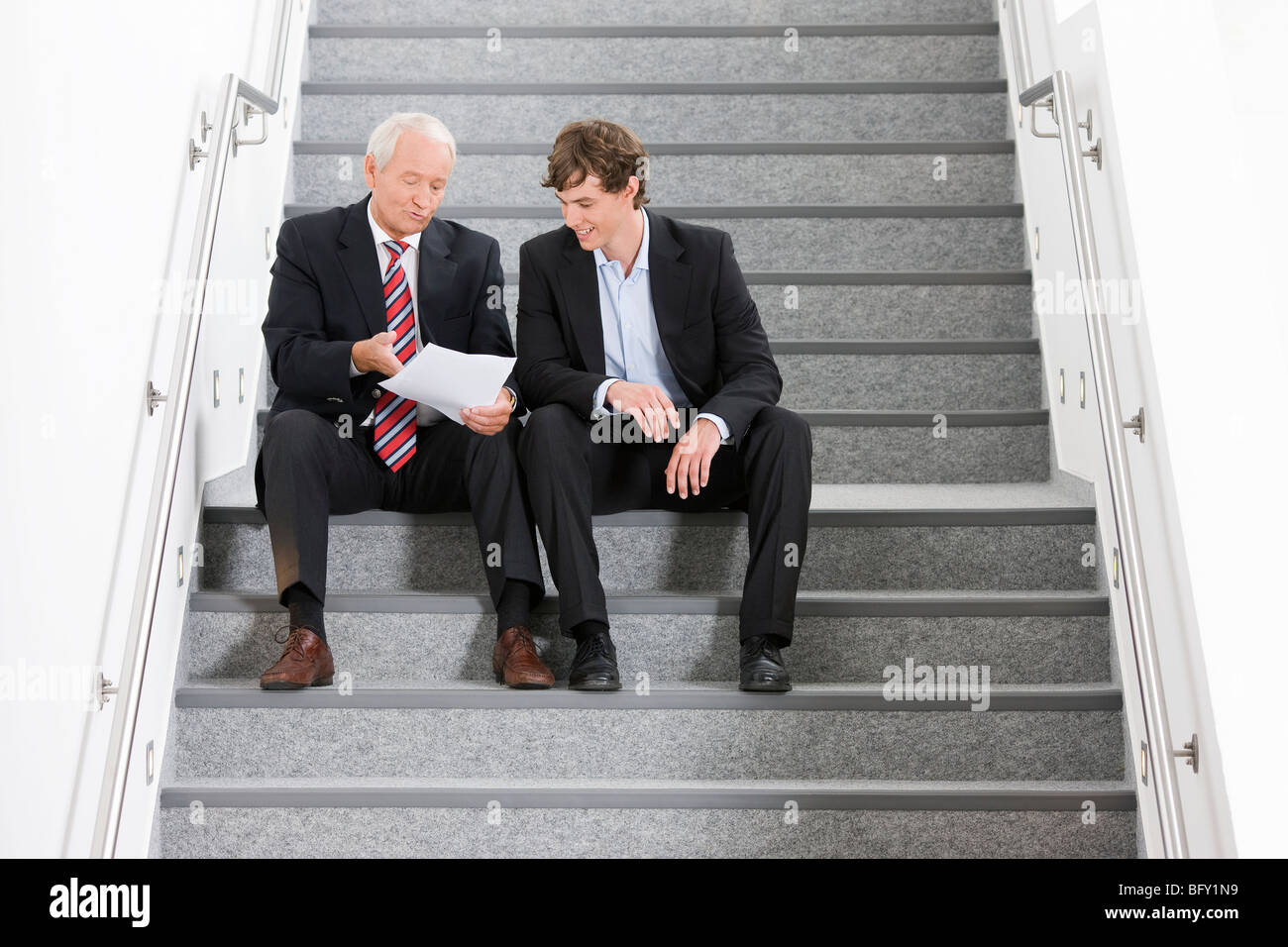 two businessmen on staircase Stock Photo - Alamy