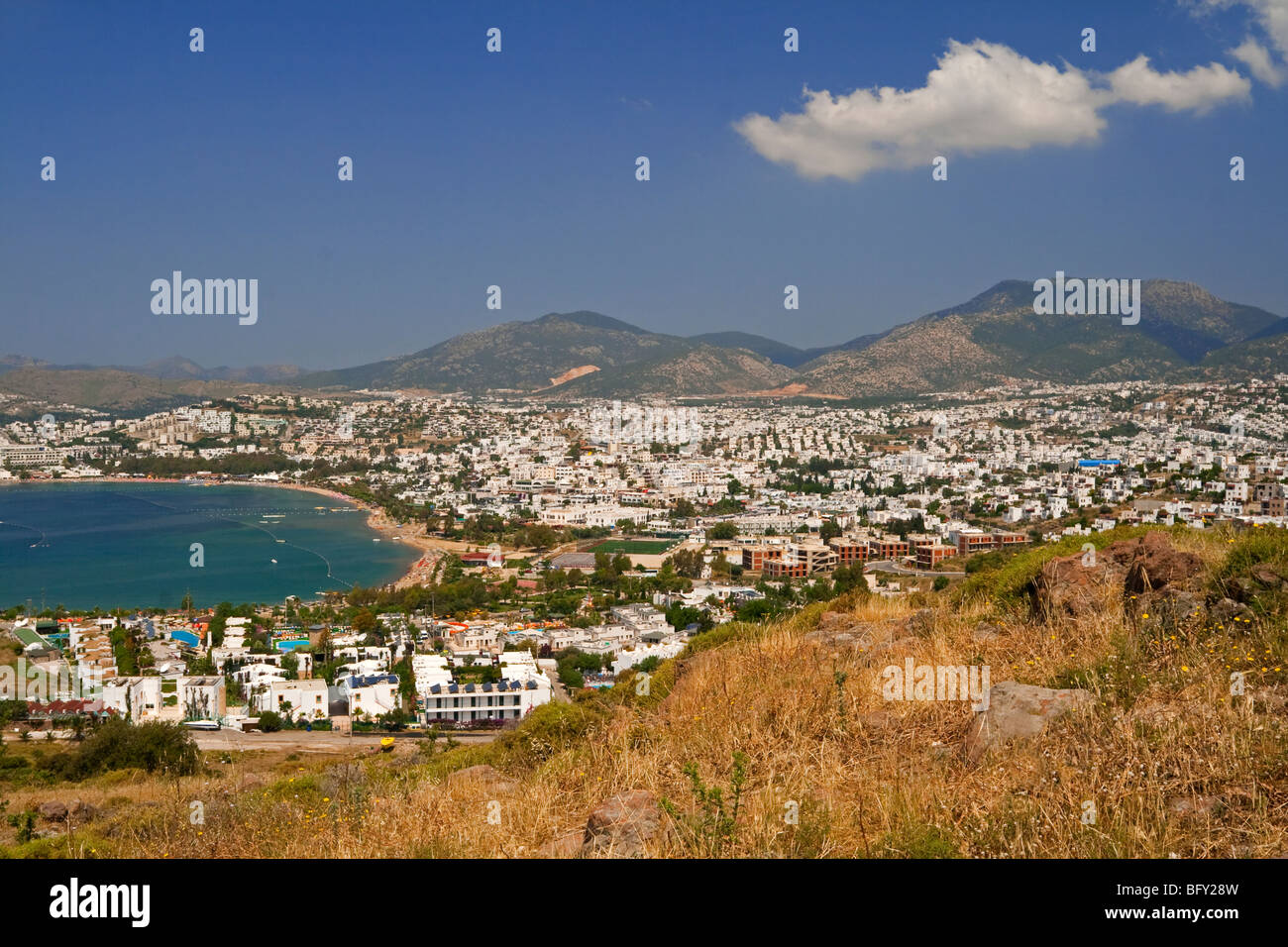 View over the tourist resort of Gumbet near Bodrum in western Turkey showing holiday villas and apartments with mountains behind Stock Photo
