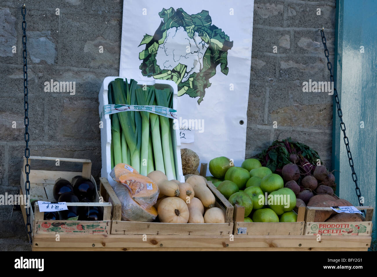 Colourful display of fresh organic vegetables in a box against a wall for sale Stock Photo